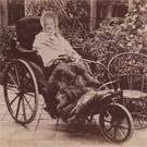 Elderly woman in a bath chair